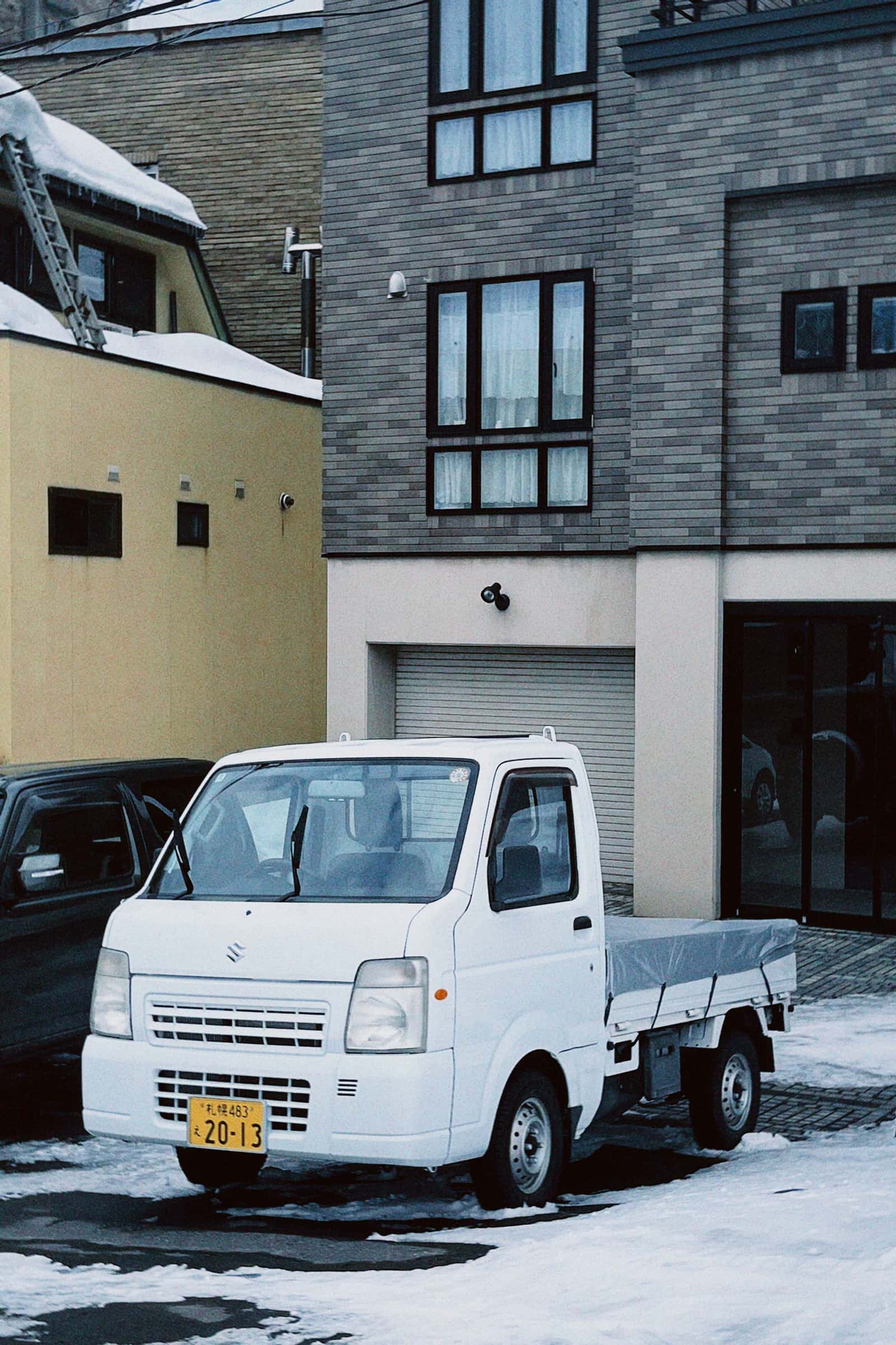 Japanese kei truck parked on a US farm property